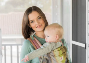 Alyce Mostert with a baby in a baby carrier